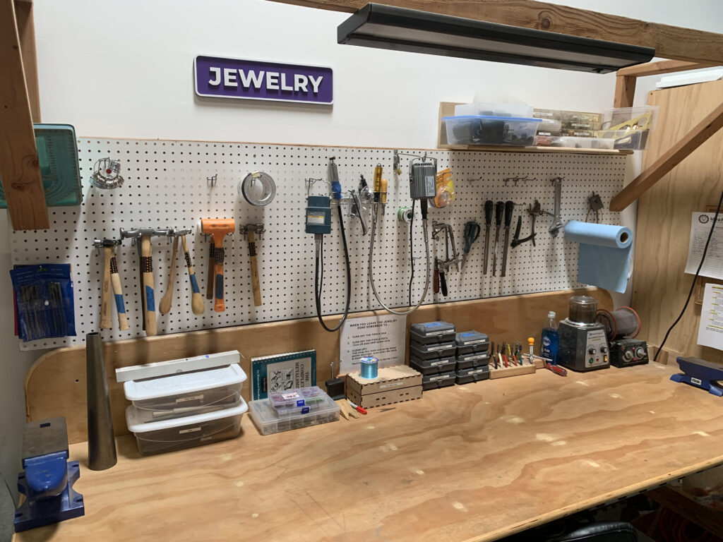 Jewelry Workbench with assorted tools and sign with text "Jewelry"